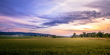 Rural Sunset Landscape of Swiss Farmland With Tractor And Farm-House In Background