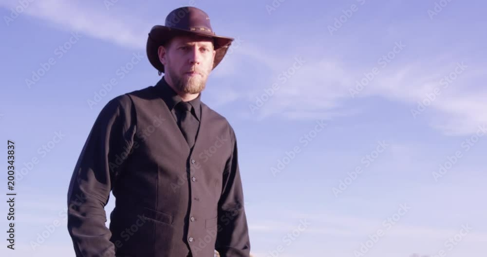 Angry Cowboy standing in desert - camera moving away? Angry Cowboy standing in desert - camera moving away?