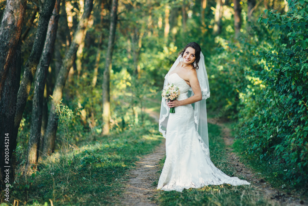Beautiful bride outdoors in a forest