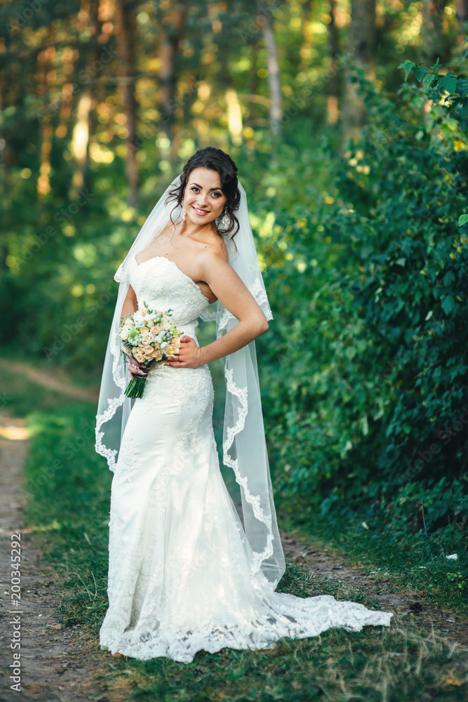 Beautiful bride outdoors in a forest Beautiful bride outdoors in a forest