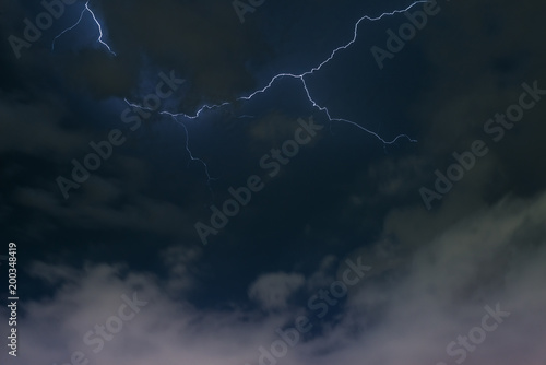 Stroke of lightning with storm clouds