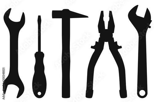 Industrial tools kit - spanner, screwdriver, hammer, pliers, adjustable wrench. Black silhouettes