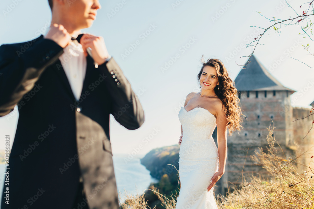 Walk just married on the background of the old castle