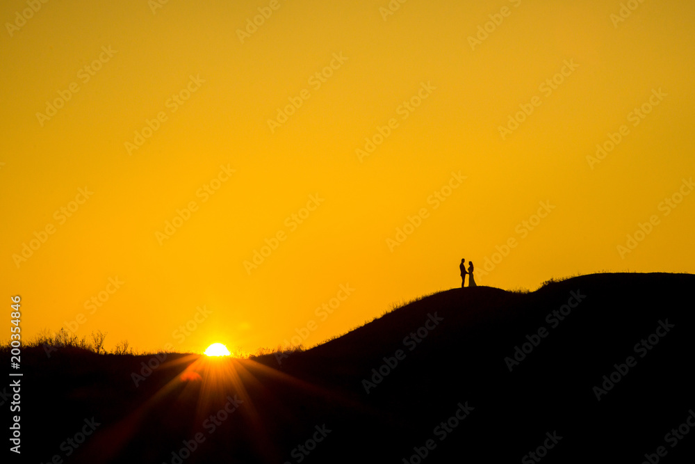 Romantic bride and groom watching sunset
