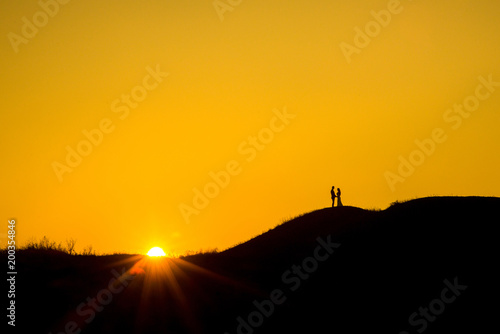 Romantic bride and groom watching sunset