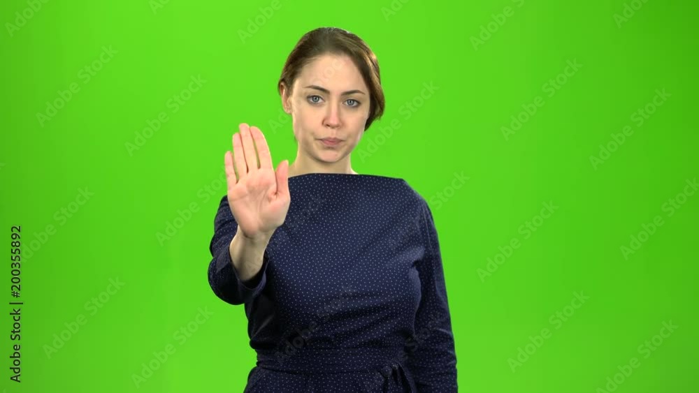 Director woman shows a stop to her subordinates. Green screen