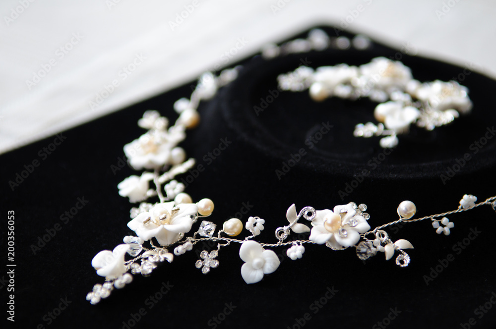 Necklace on black velvet. Decoration in the form of flowers.