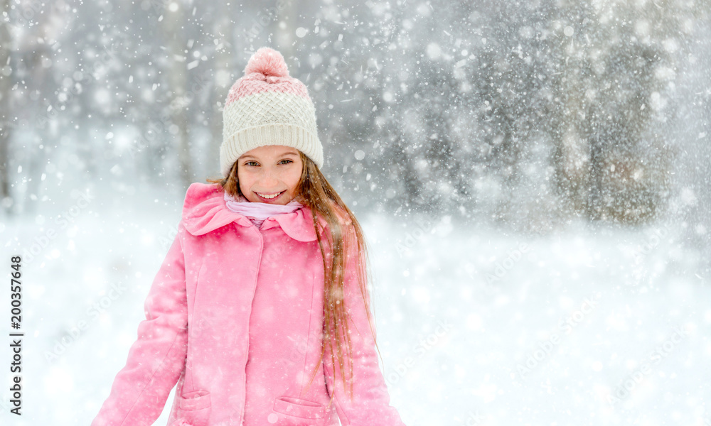 Smiling girl in whirl of snowflakes Smiling girl in whirl of snowflakes