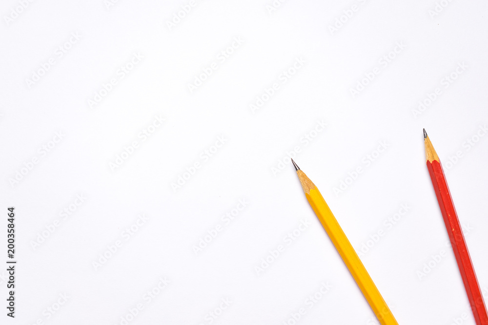 Bright colorful pencils next to a blank sheet of paper. School supplies stationery on a wooden texture table. Trendy minimalism. Concept back to school. Top view Bright colorful pencils next to a blank sheet of paper. School supplies stationery on a wooden texture table. Trendy minimalism. Concept back to school. Top view