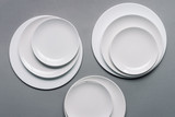 Composition of white plates on grey background
