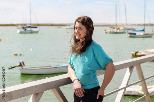 Emotional portrait of a girl on a dock near the sea. Portugal