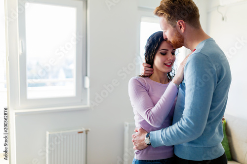 Young happy couple having romantic times at home