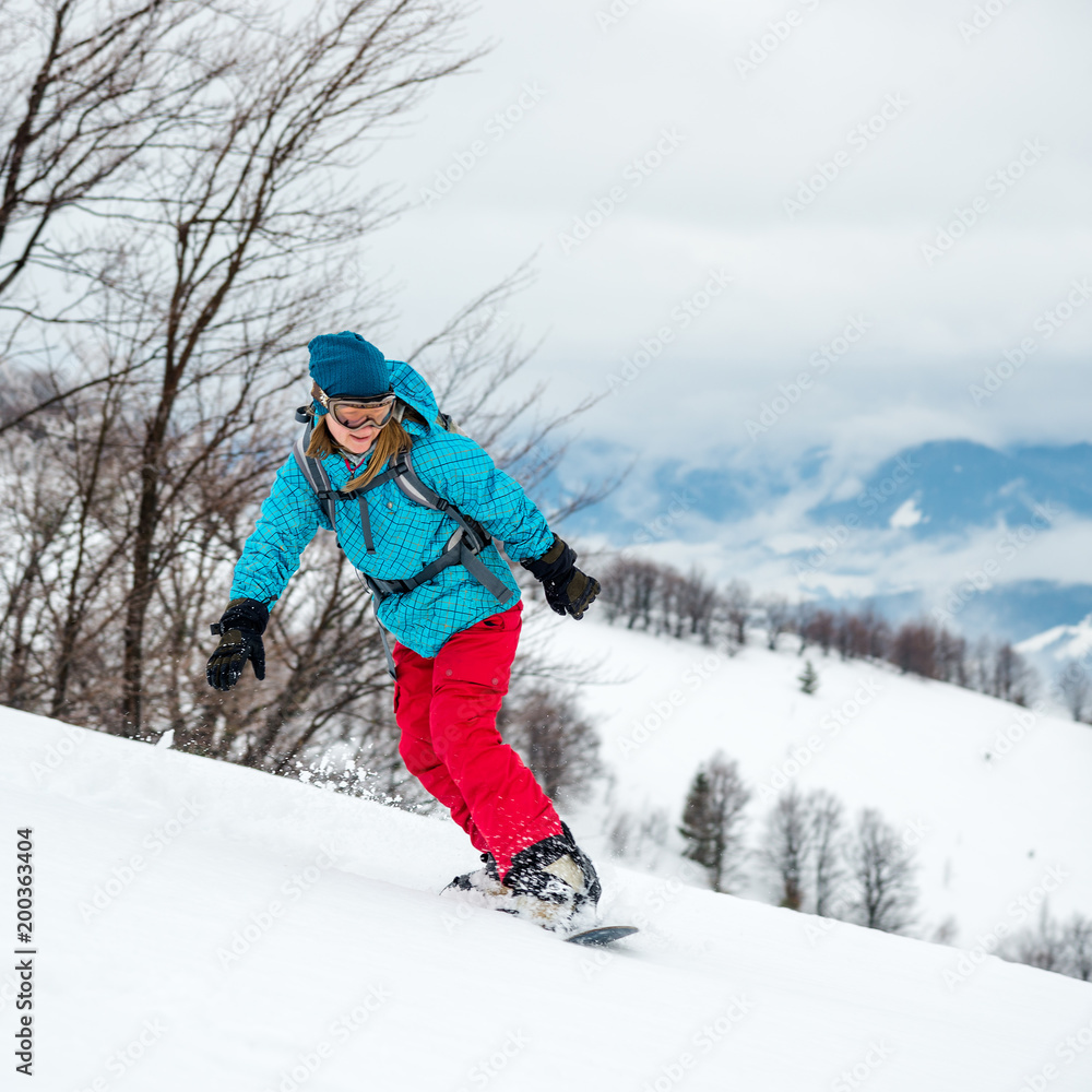 Young woman on the snowboard