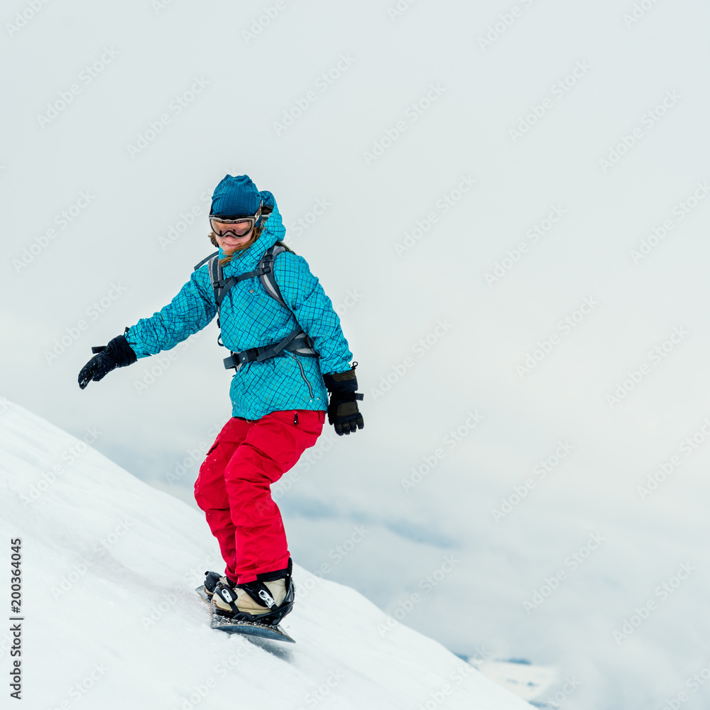 Young woman on the snowboard