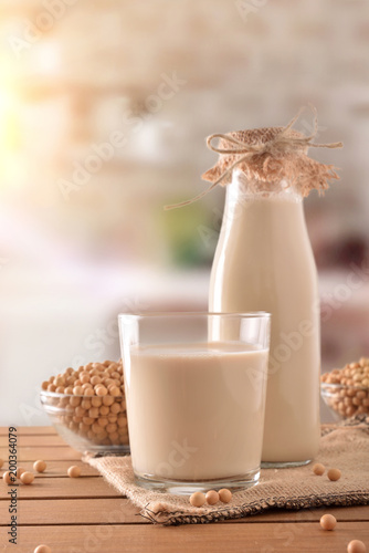 Reptientes with soy milk and grains rustic kitchen background vertical