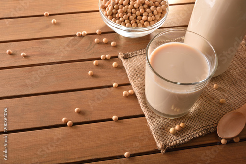 Reptientes with soy milk and grains on wooden table elevated