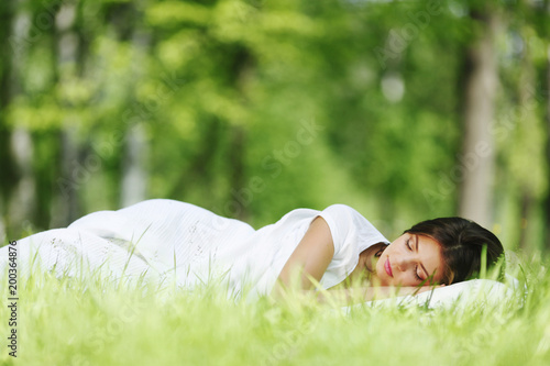 Woman sleeping on grass photo