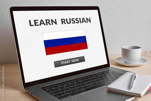 Learn Russian concept on modern laptop computer screen on wooden table. All screen content is designed by me. 
