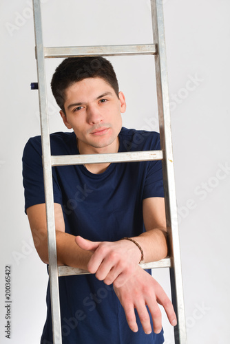 man posing near ladder. repair, design, constructor photo
