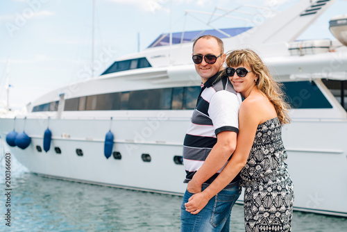 The Italian coast. Seaport. Young cute couple in love walking in the port