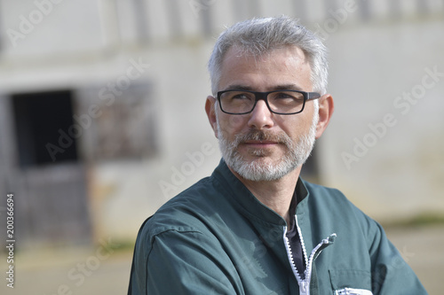 Portrait of farmer standing outside the barn