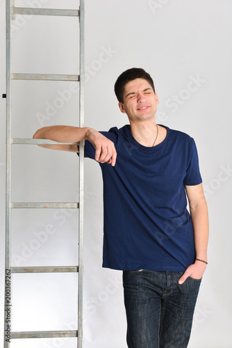 emotional man posing near ladder. repair, design, constructor photo
