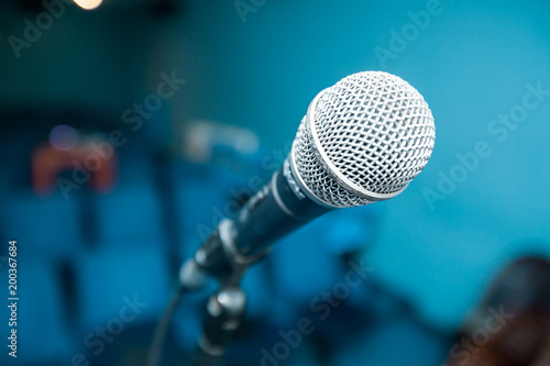 Microphone over blurred empty meeting room