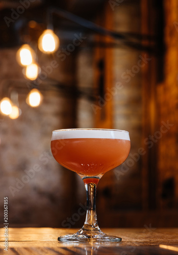 close-up view of conchita cocktail in glass on wooden table photo