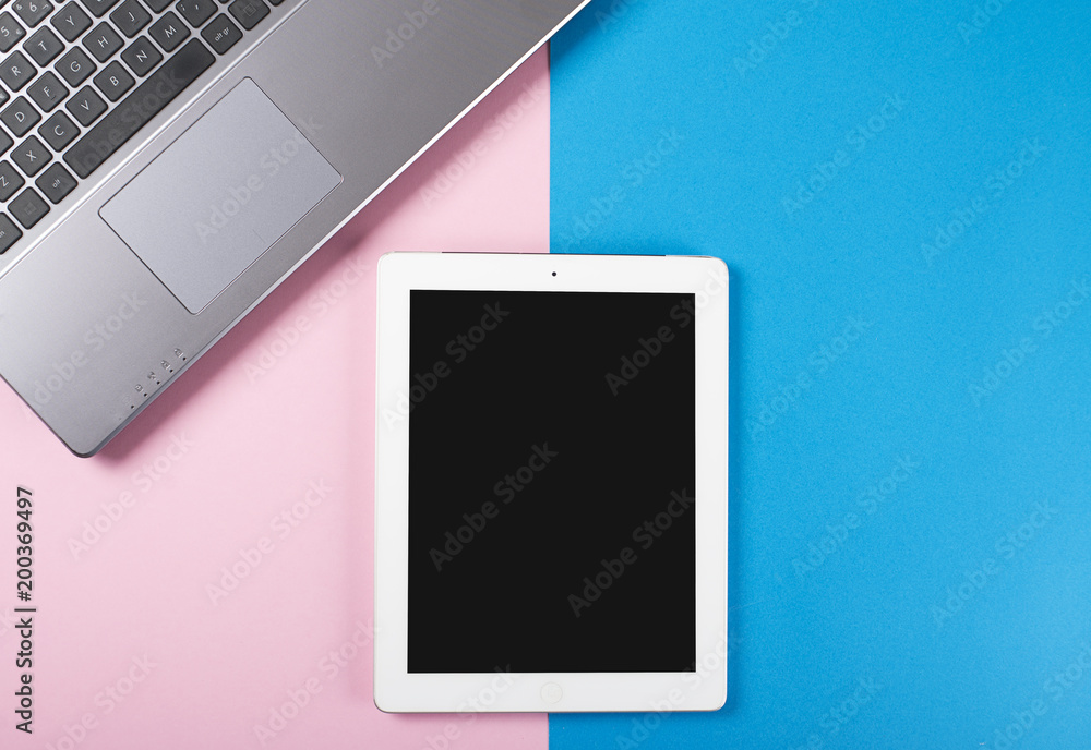 Tablet and laptop on pink and blue background. Tablet and laptop on pink and blue background.