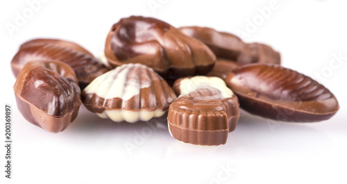 Chocolate candies in the form of seafood on white background