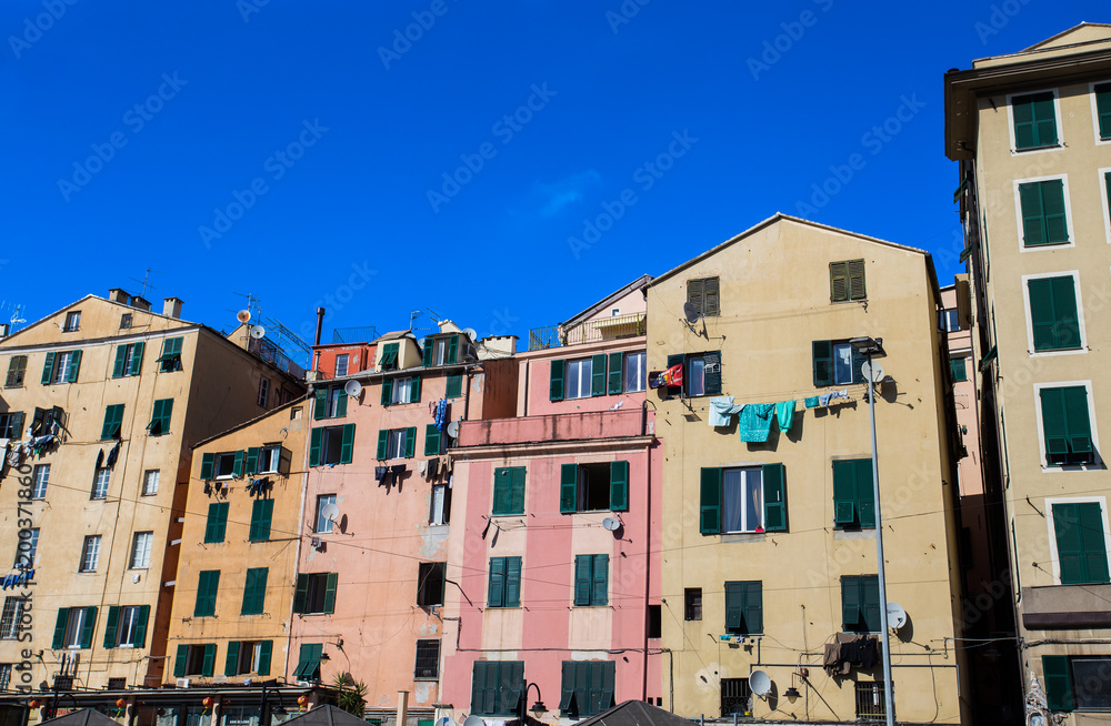 Facade of colorful buildings in the historic center of Genoa, Italy.