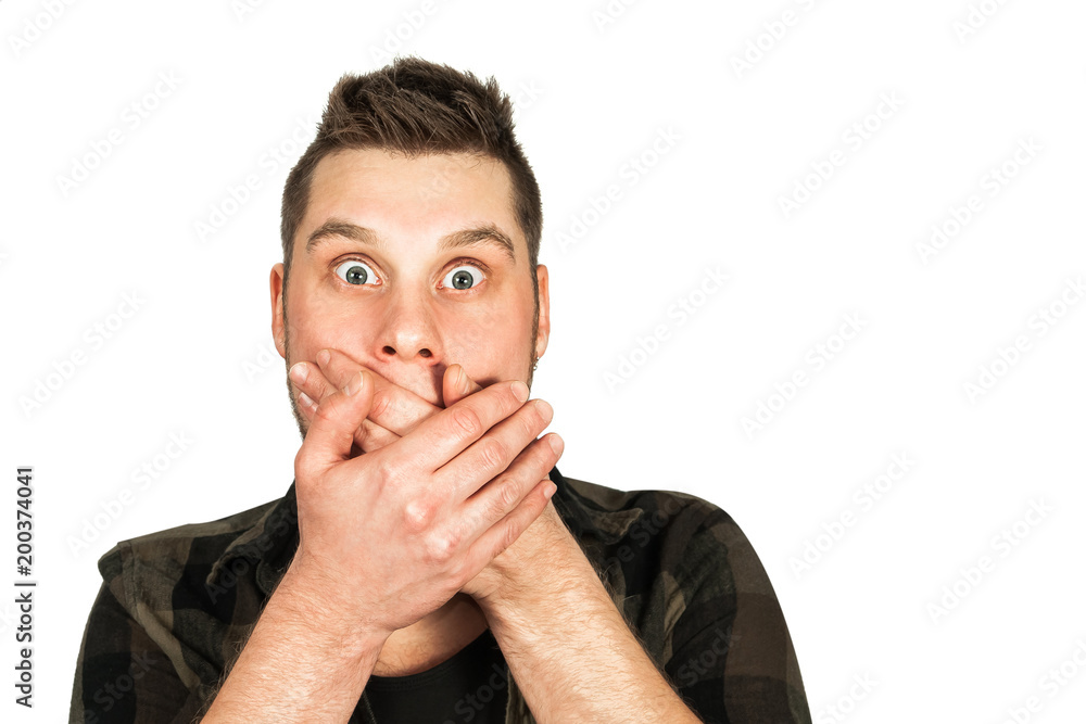 Young guy with beard and modern mohawk hairstyle, closing his mouth with his hands, isolated on white background. Young guy with beard and modern mohawk hairstyle, closing his mouth with his hands, isolated on white background.