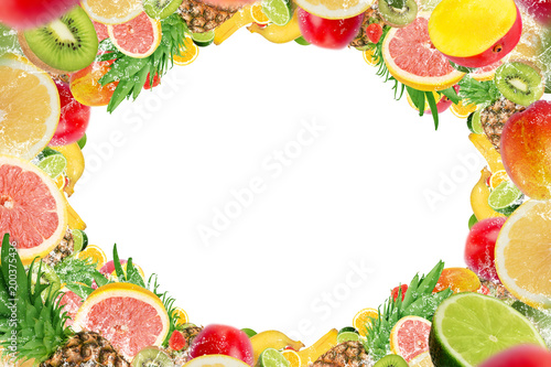 Frame of tropical fruits with water splash on white background, empty space in the middle