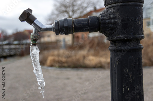 Icicle hanging from tap