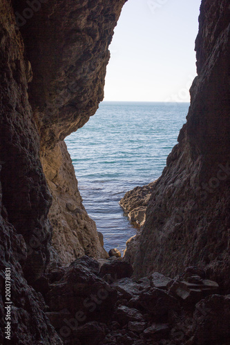 Stunning views of the sea from the natural cave. © danilsneg