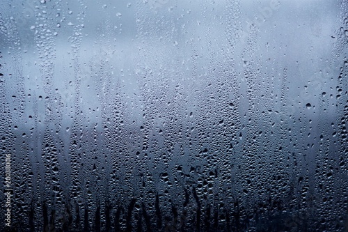 Rain drops or condensation on the glass. It is a cold autumn or winter