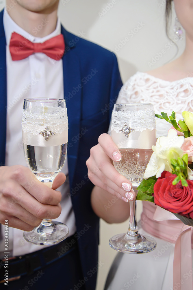 Newlyweds holding wedding champagne glasses Newlyweds holding wedding champagne glasses