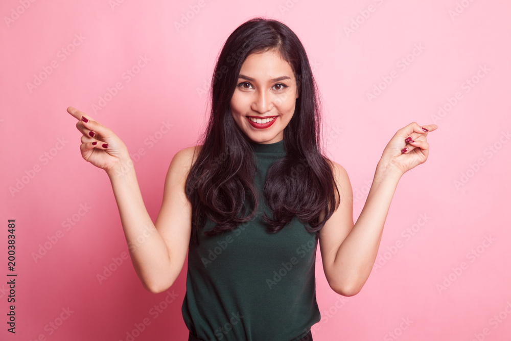 Young Asian woman point to left and right. Young Asian woman point to left and right.