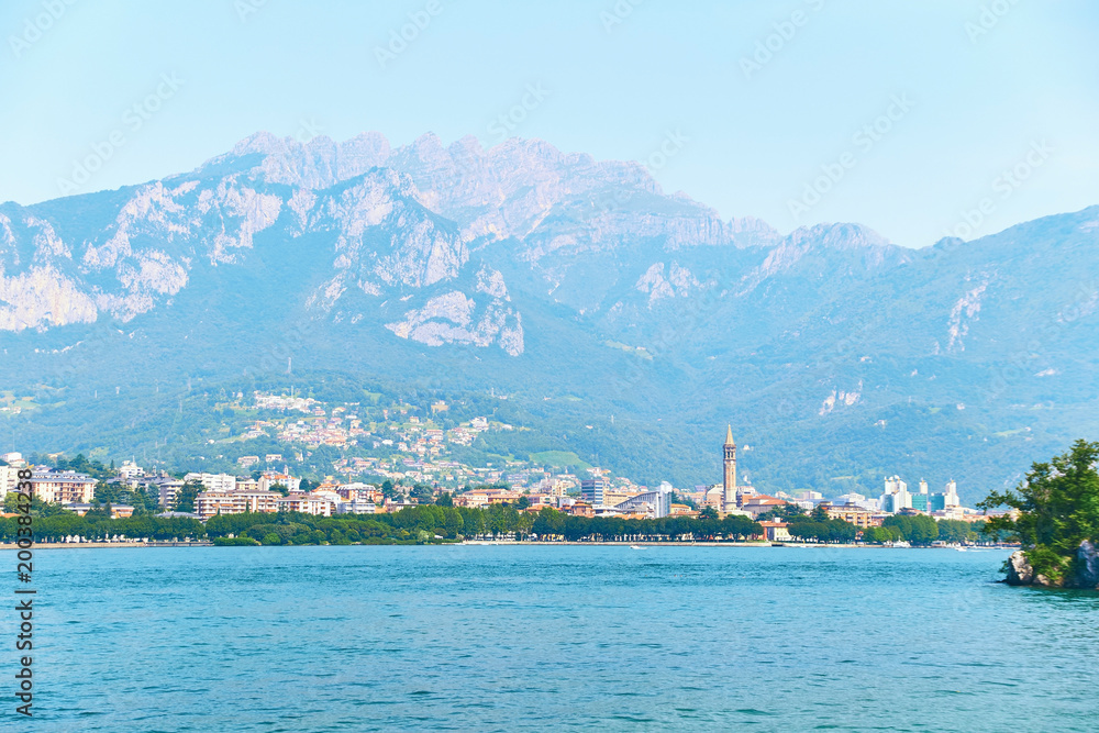 Beautiful summer view of the city of Lecco in Italy on the shore of lake Como with visible famous bell tower of the Basilica of San Nicolo.
