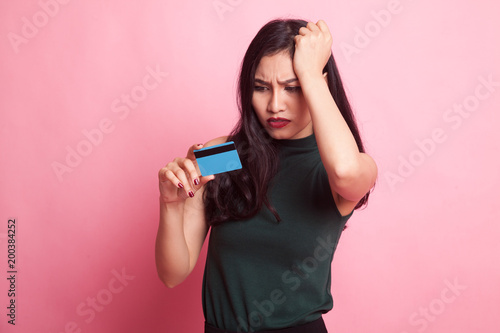 Young Asian woman headache with a blank card.