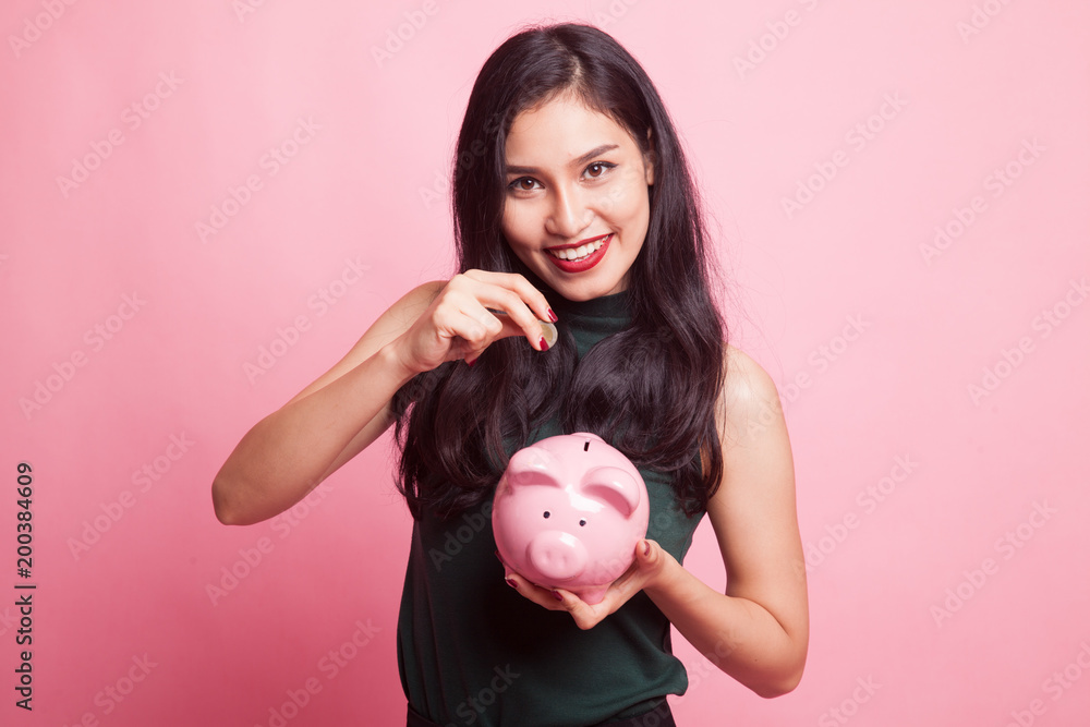 Asian woman with coin and pig coin bank. Asian woman with coin and pig coin bank.