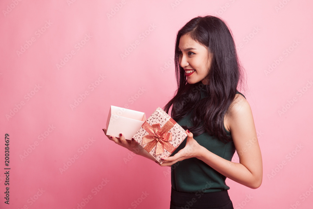 Young Asian woman open a gift box. Young Asian woman open a gift box.