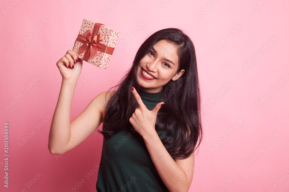 Young Asian woman with a gift box. Young Asian woman with a gift box.
