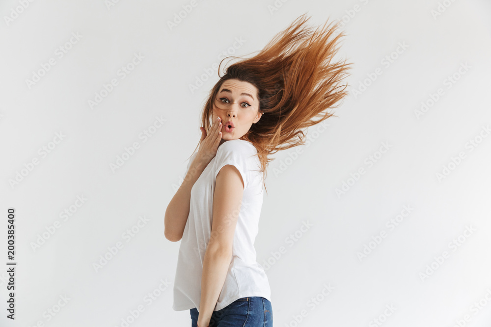 Side view of Surprised woman in t-shirt touchin her cheek Side view of Surprised woman in t-shirt touchin her cheek