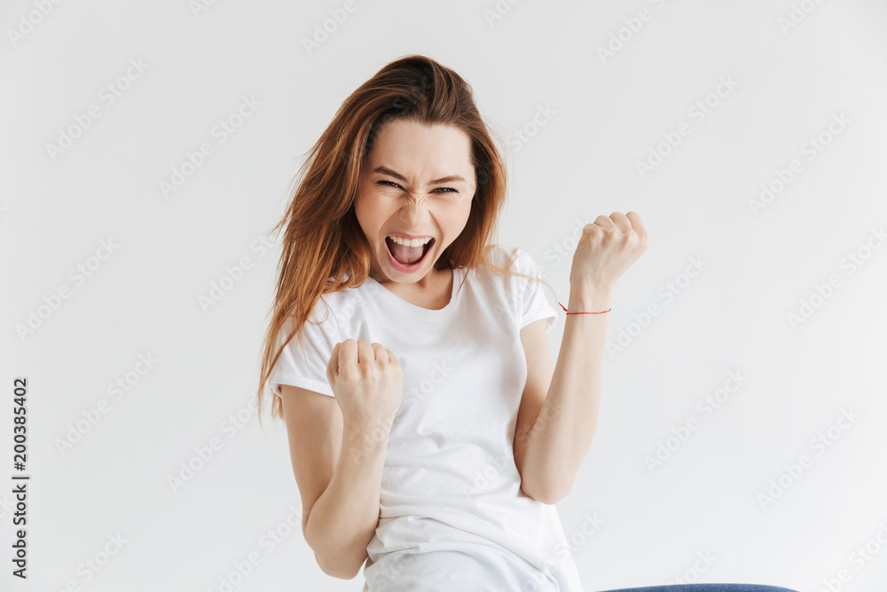 Happy woman in t-shirt screaming and rejoices Happy woman in t-shirt screaming and rejoices