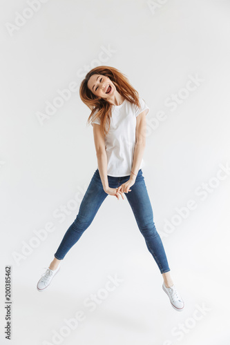 Full length image of Funny woman in t-shirt having fun