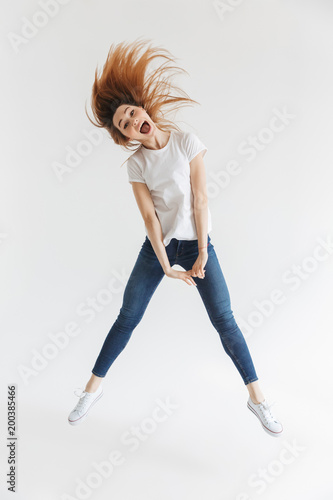 Full length image of Joyful woman in t-shirt having fun
