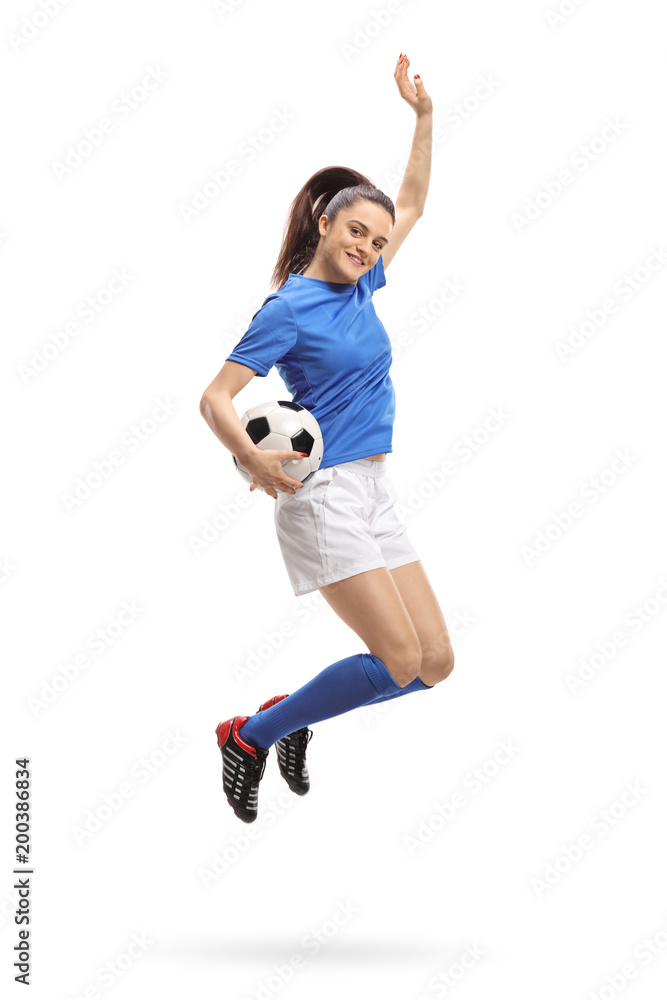 Female soccer player jumping and gesturing happiness