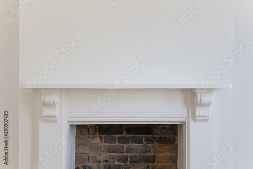 Victoriran wooden fireplace surround with white walls