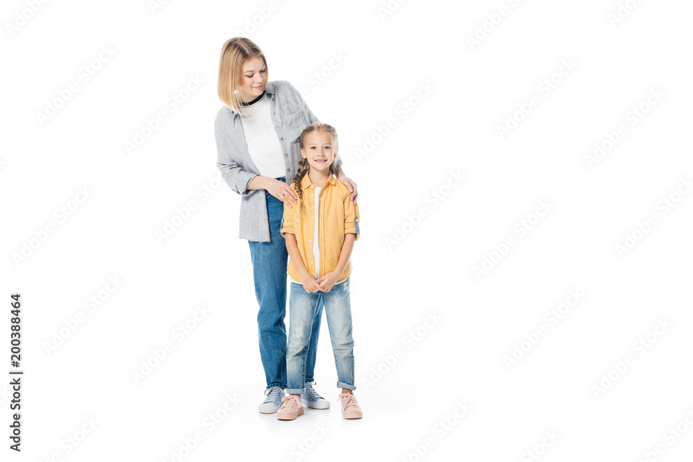smiling mother and little daughter isolated on white